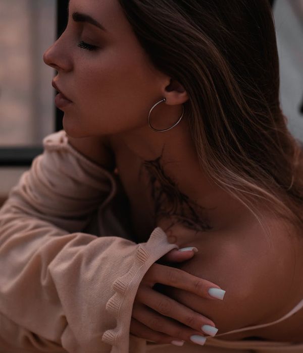 Woman gently closing her eyes in a calm, focused state, with a serene expression.